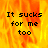 Pixelated text "It sucks for me too" on a fiery orange-yellow background with one gray