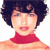 Pixelated portrait of a person with short dark hair wearing a red turtleneck sweater against a white background.