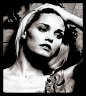 Four black-and-white portrait arranged in a showing the same woman with varying poses, expressions, and hair styling