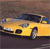 Yellow taxi cab with dark roof and visible wheels on a brownish background.