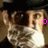 A pixelated image of a person with dark hair and beard, wearing a black cap, showing three sequential facial expressions with pink text overlays.