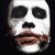 Three identical pixelated faces with white skin, black eyes, and brown lips arranged in a on dark background