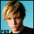 Pixelated static image of a person with light brown hair against a solid blue background, featuring the word "FAN" in blocky text at bottom left.