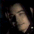 A pixelated image shows a person with light skin and short hair resting their head on one hand against a dark background, next to green text reading 'Original Icons .com' in stylized font.