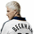 Pixelated image of a person with short light hair in profile view, wearing a white jacket with dark stripes and a dark collar, next to blue background with yellow text.