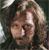 Pixelated static image of a person with long wavy hair and visible facial features against a dark background.