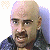 A pixelated contact sheet showing two frames of an animated icon featuring a bald man with mustache on left and green text logo on right against dark background.