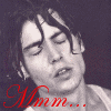 nine identical monochrome images showing a person with dark hair and closed eyes, overlaid with red and purple text reading "Mmm..." and "Wet Johnny." The background is solid black
