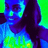 Pixelated image of a person with dark hair and blue clothing against a green background, rendered in a low-resolution, high-contrast color palette.