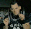 A person in a dark jersey with white trim and 'MAD' text appears in four showing hand gestures changing from pointing to open palm