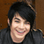 A split-screen image shows a person with dark hair and a black shirt on the left, next to text reading "Adam Lambert on american idol" on the right.