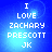 Blue background with white pixelated text reading "I LOVE ZACHARY PRESCOTT JK" in four , displayed in a of four identical