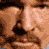 A pixelated promotional image for 'The Longest Yard' featuring three close-up faces above bold text and a release date.