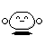 Pixelated white character with rounded head, black eyes and mouth, two small circular side elements, and a solid black base on gray background.