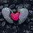 A static pixel art icon featuring a red heart with gray wings against a dark stone background.