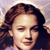 Pixelated close-up of a person with brown curly hair, closed eyes, and a neutral expression against a light purple background.