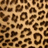 A static image of a leopard print pattern with irregular dark brown spots on a light tan background.