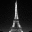 Pixelated grayscale Eiffel Tower on left, bright pink text 'Holey' on right against black background.