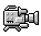 Pixelated gray video camera icon with black outlines, four square buttons on front, two legs at base, and a lens extending from right side.