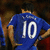Pixelated image of a person wearing a blue sports jersey with white number 10 on the back, standing against a dark background.
