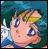 Pixelated cartoon-style face with large eyes and light skin, set against a blue-green gradient background with white and blue accents.