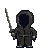 Pixelated figure in dark hooded cloak holding a long staff, standing against plain gray background.