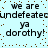 Pixelated text repeats 'we are undefeated ya dorthy!' on a light blue background with scattered brown dots.
