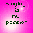 Four identical display the text "singing is my passion" in dark green pixelated font on a pink gradient background with white light effects