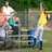 Pixelated image of two figures in a sports setting with green background, one in white and teal, the other in yellow and blue.