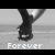 Black-and-white pixelated image of two hands clasped together above a gray background with the word 'Forever' in white text at the bottom.