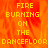 Pixelated yellow text reads "FIRE BURNING ON THE DANCEFLOOR" over a fiery orange-red background with visible flame-like motion.