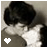 Static 48x48 pixel icon showing a close-up of two figures kissing with dark hair and light skin tones, featuring a white heart symbol in the lower-left corner on a gray background.