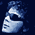 Pixelated blue and white icon shows a stylized face with closed eyes and a curved mouth against a dark blue background with scattered light blue fragments.