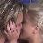 Pixelated image of two figures in close physical proximity with visible skin tones and dark hair against a blurred background.