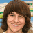 Pixelated image of a smiling person with brown hair, next to text reading 'mitchel is a hottie <33' on a black background.