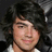 A pixelated image of a person with dark tousled hair and light skin, next to a black-and-white '<3' symbol on white background.