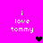 Pixelated text 'i love tommy' on bright pink background with a black heart icon in the center.