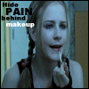 A person with braided hair applies makeup while text reads "Hide PAIN behind makeup" in the upper left.