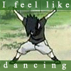 A character with spiky black hair and dark clothing strikes a wide stance with arms raised, set against a blurred green and beige background with text above and below.