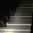 Pixelated image with dark piano keys on left and brown text reading 'listen to the music in your HEART<33' on white background.