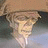 A pixelated character with light brown hair and a beige head covering, partially obscured by a black with white text