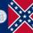 Pixelated image of a red and blue flag with white diagonal stripes forming a cross, set against a dark blue background.