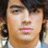 A static image with a red background, a portrait of a person with dark hair, and white text reading 'I love joe' in pixelated font.