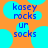 Pixelated blue text on orange background with cyan circles; 'kosey rocks' and 'ur socks' text visible in two identical side-by-side
