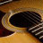 A split-screen image with a close-up of an acoustic guitar's soundhole on the left and green text reading 'OriginalIcons.com' on a dark green background on the right.