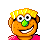 Pixelated cartoon face with orange skin, green nose, yellow hair, and pink shirt against gray background.