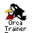 Pixelated image of a character with blonde hair and red clothing being embraced by a large black-and-white orca, with text below reading "Orca Trainer".