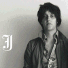 A black-and-white portrait of a person in a jacket and patterned shirt with changing text overlays in different fonts and colors.