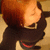 A person with reddish-brown hair in a black outfit appears to shift position across four , showing slight variations in head angle and shoulder alignment
