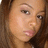 Static close-up of a person's face with light skin tone, brown hair visible on the left side, and neutral expression.